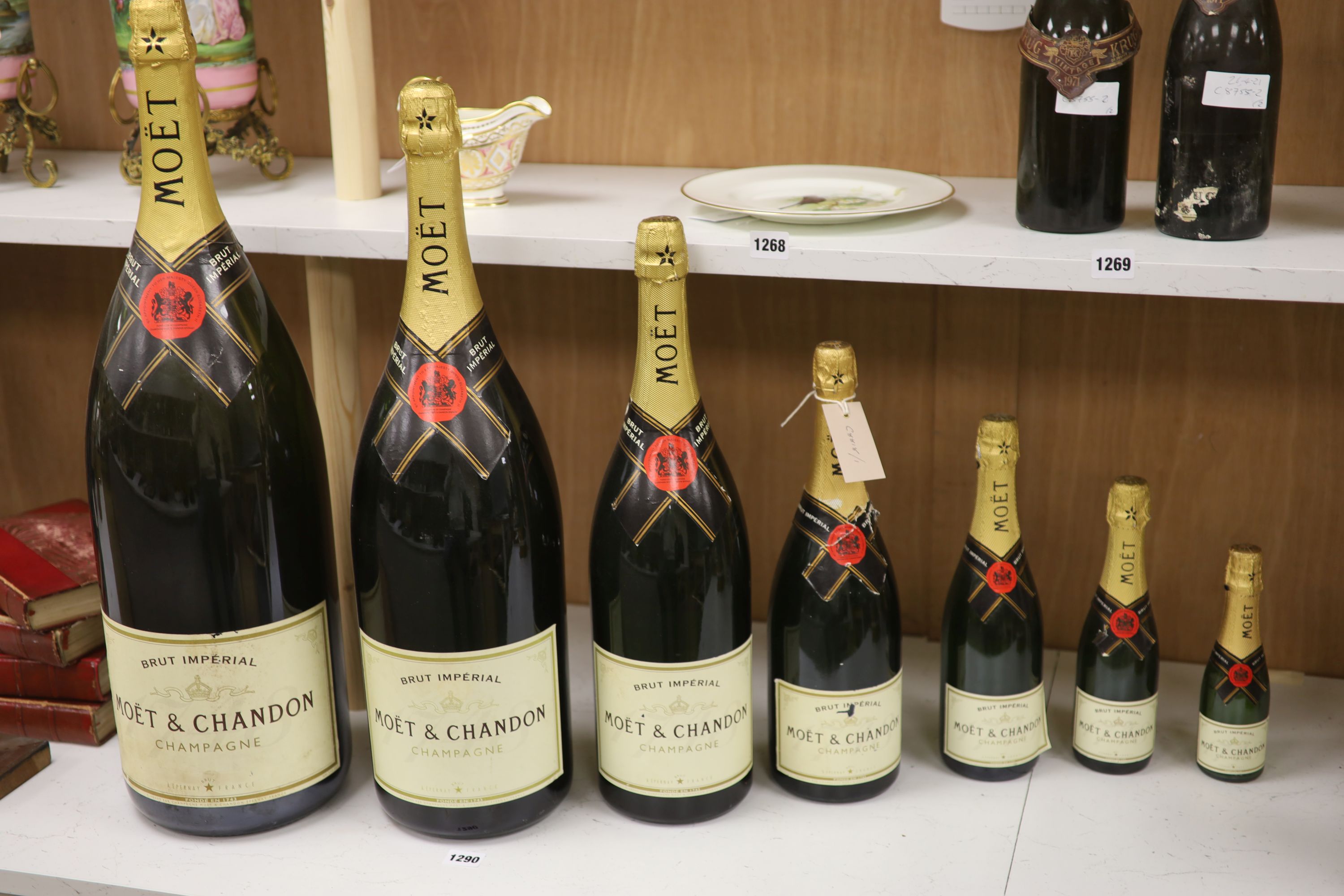 A graduated set of seven Moet & Chandon champagne advertising bottles, tallest 67cm